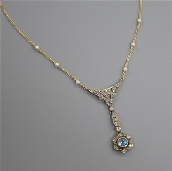 An Edwardian style yellow metal, blue topaz, diamond and seed pearl set drop pendant necklace, pendant 5cm.